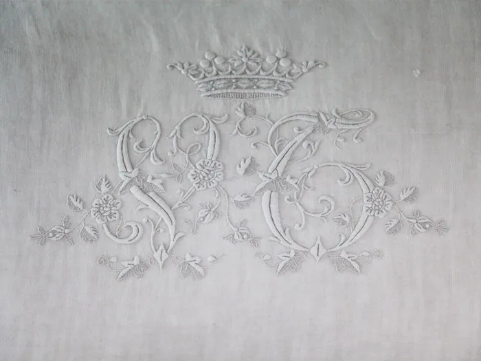 A rare antique monogram 'VC' with crown on linen bolster by Charlotte Casadéjus